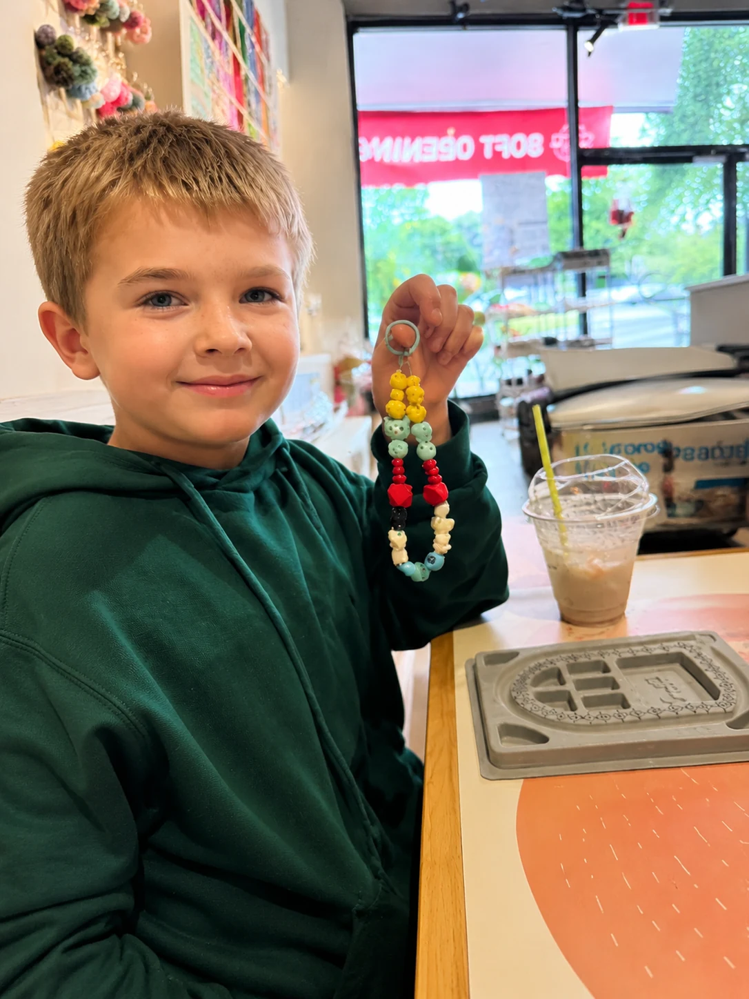 Kid showing handmade phone charm